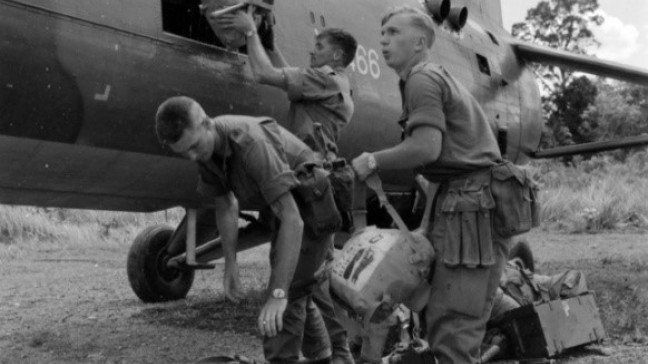 Three unidentified Australian soldiers of 3rd Battalion, The Royal Australian Regiment (3RAR), loading packs and other equipment onboard a Royal Air Force (RAF) Westland (Bristol) Belvedere helicopter (with a serial number ending in 466). The heavy lift chopper is bound for one of the 3RAR forward company base in Sarawak, close to the Indonesian border.